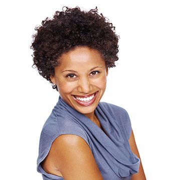 Portrait of an attractive African-American woman smiling isolated on white background
